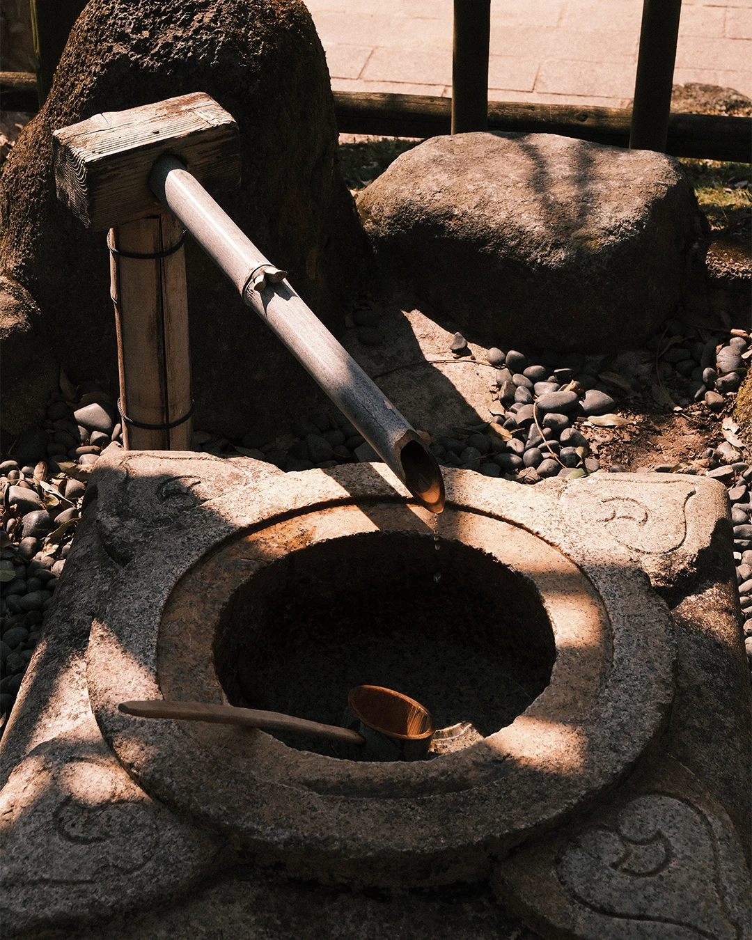 Stenen waterbekken met een bamboe waterspuwer in Nara